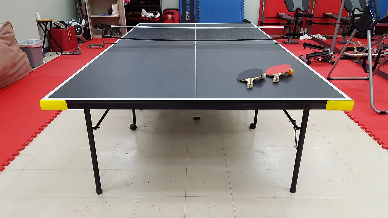 A table-tennis table, net and two rackets