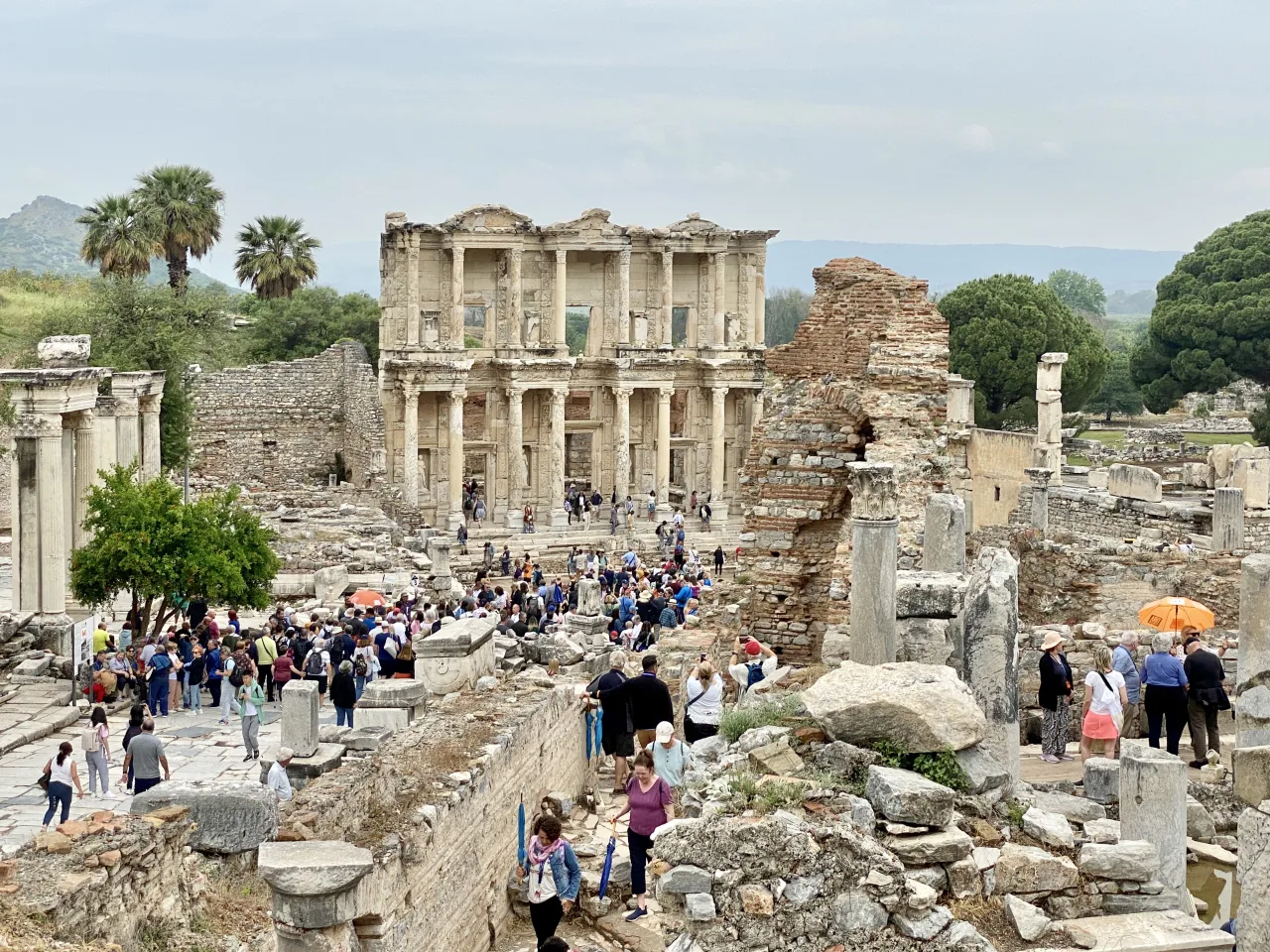 Reconstructed Library of Celsus façade, ruins and visitors at Ephesus