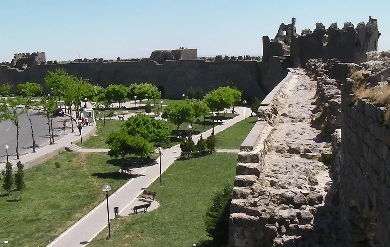 Walls, towers and a green space seen from inside Diyarbakır's fortifications