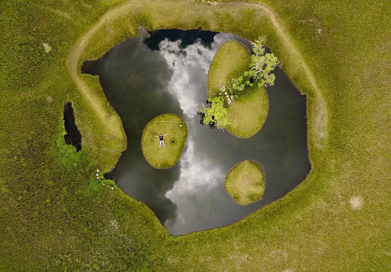 An overhead view of the water and three vegetated islets at Solhan's Floating Islands