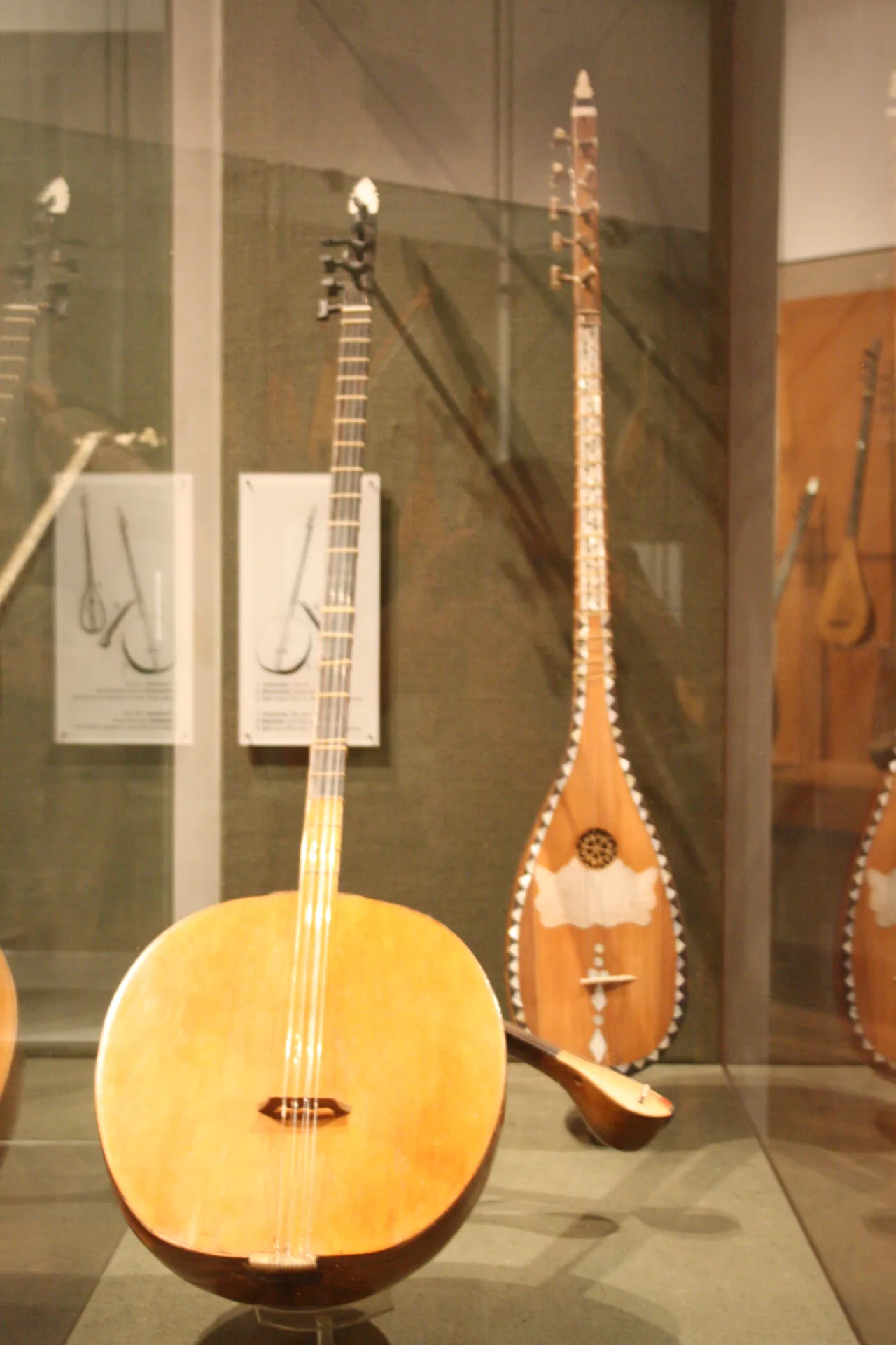 An Ottoman tanbur at left among string instruments in Athens' Museum of Greek Folk Instruments; not instruments owned by the artist.